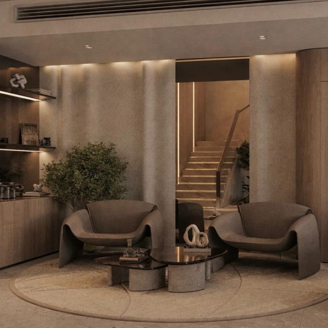 Sodic East Home — living seating area with sculptural armchairs and illuminated staircase